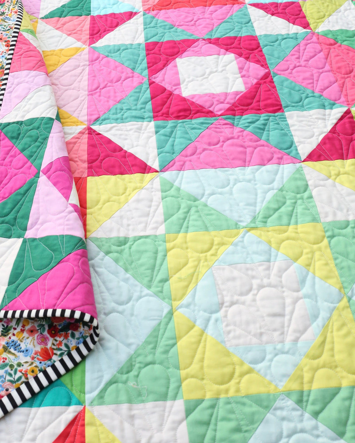 Close-up of Economy Stars blocks with the quilt corner folded back